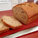banana bread with knife on cutting board