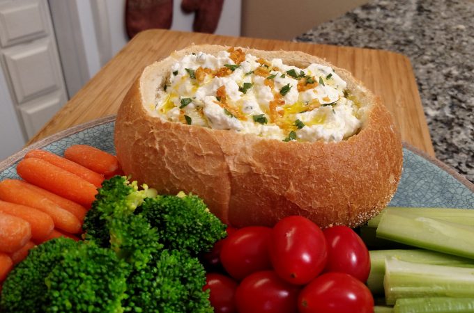 vegetable dip in a bread bowl