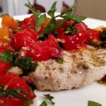 grilled swordfish with tomatoes and capers on a plate