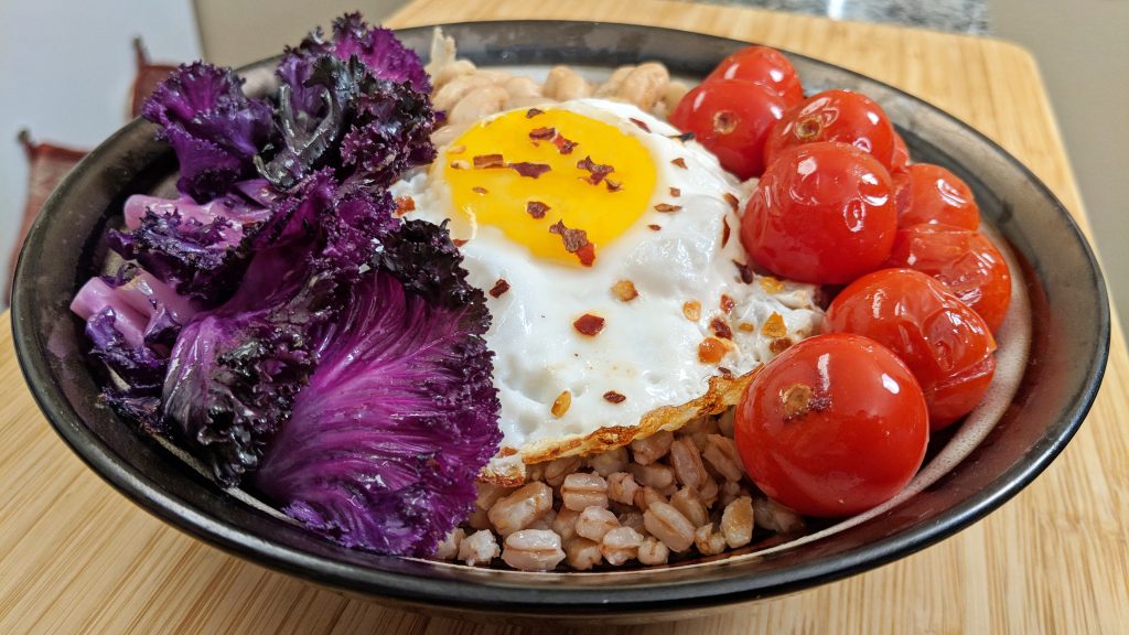 Farro Grain Bowl with Purple Kale, Cherry Tomatoes, Cannellini Bean and a Fried Egg
