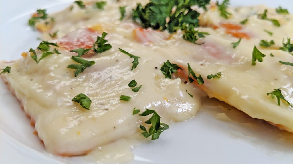 Ravioli in a Cream Sauce on white plate with parsley