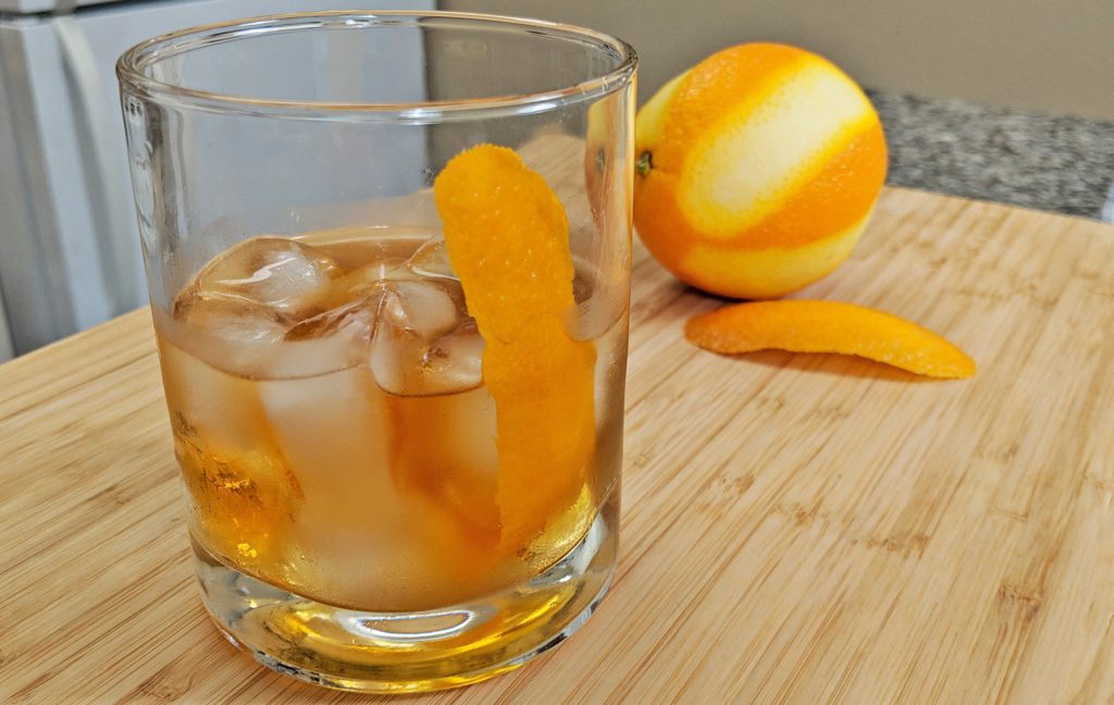 Old Fashioned Cocktail in Double Rocks Glass with Orange Zest